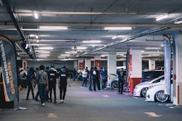 a group of people standing in a parking garage