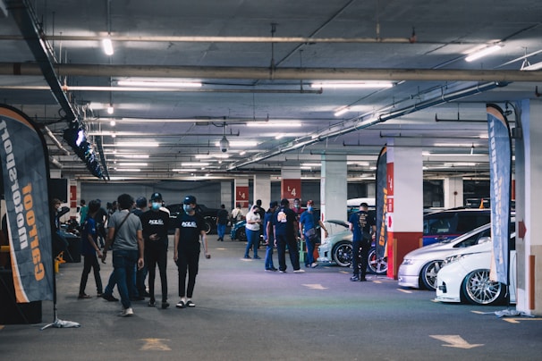a group of people standing in a parking garage
