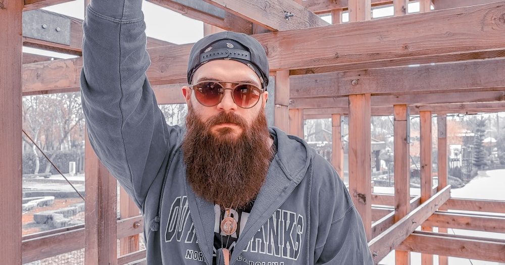 a man with a beard wearing sunglasses and a hat