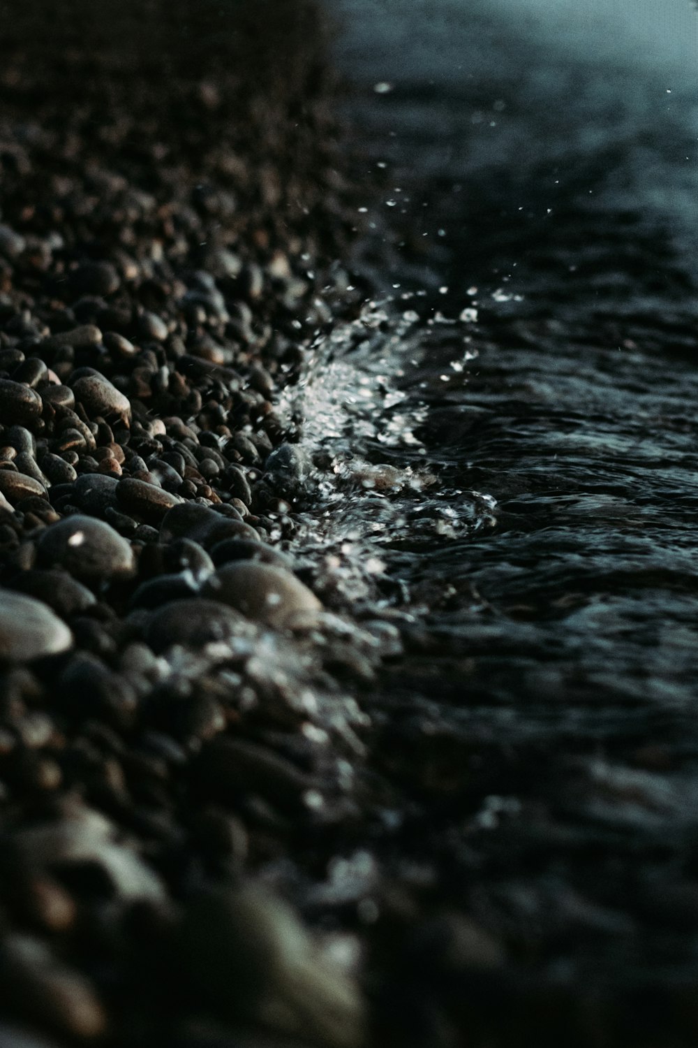 a close up of rocks and water on a beach