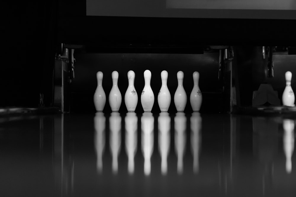 a black and white photo of bowling pins