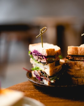 a plate with a cut in half sandwich on it
