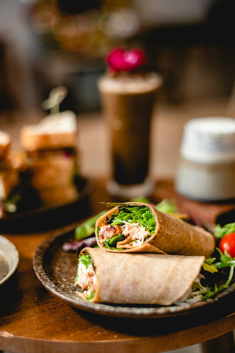 a plate with a burrito and salad on it