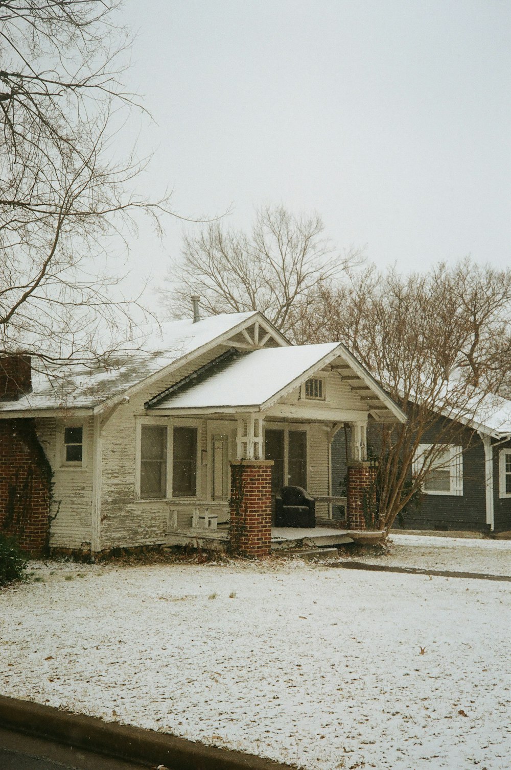 a white house with snow on the ground