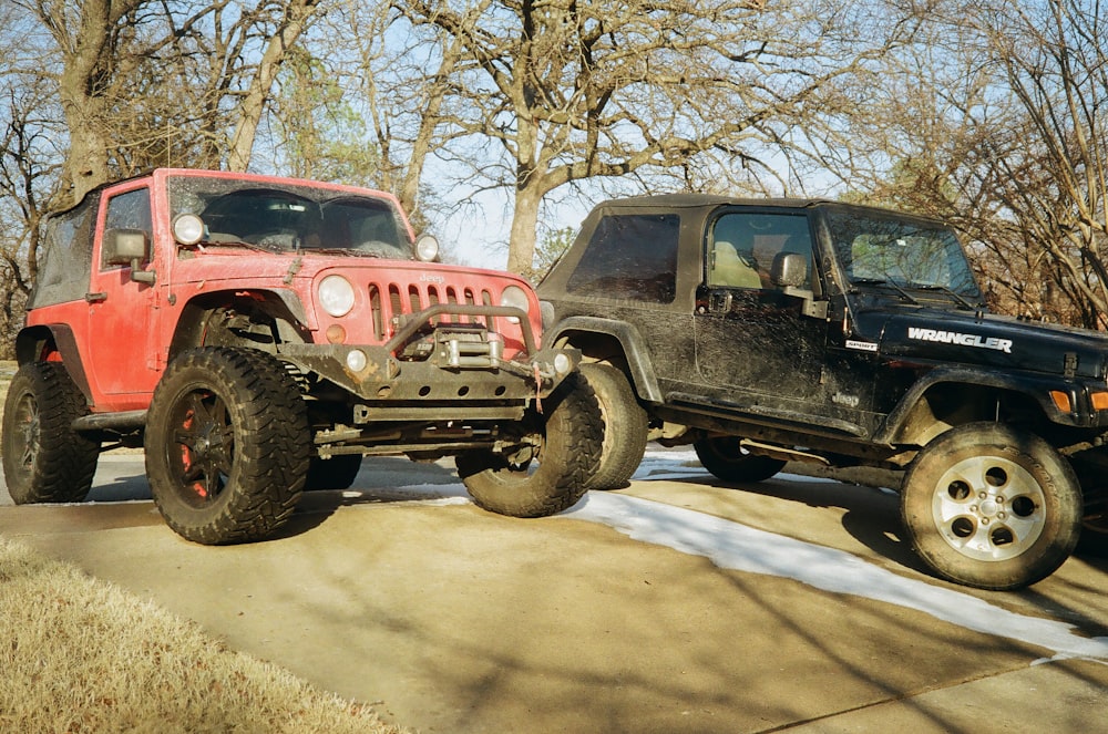 two jeeps parked next to each other in a parking lot