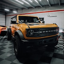 a yellow truck is parked in a garage