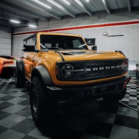 a yellow truck is parked in a garage
