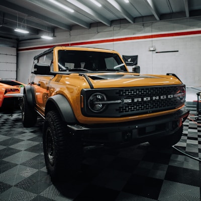 a yellow truck is parked in a garage