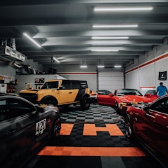 a garage filled with lots of different colored cars