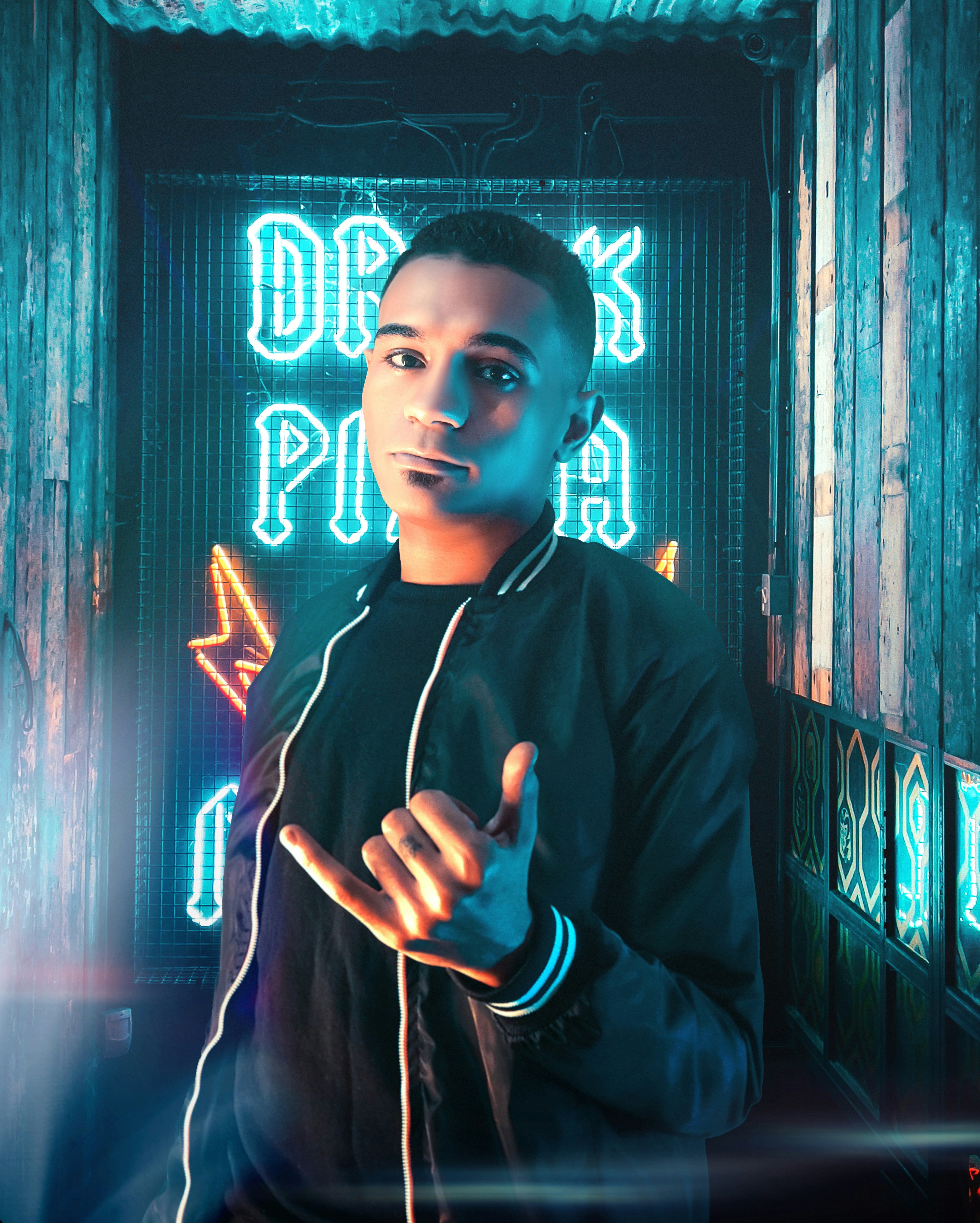 a man in a dark room with neon lights