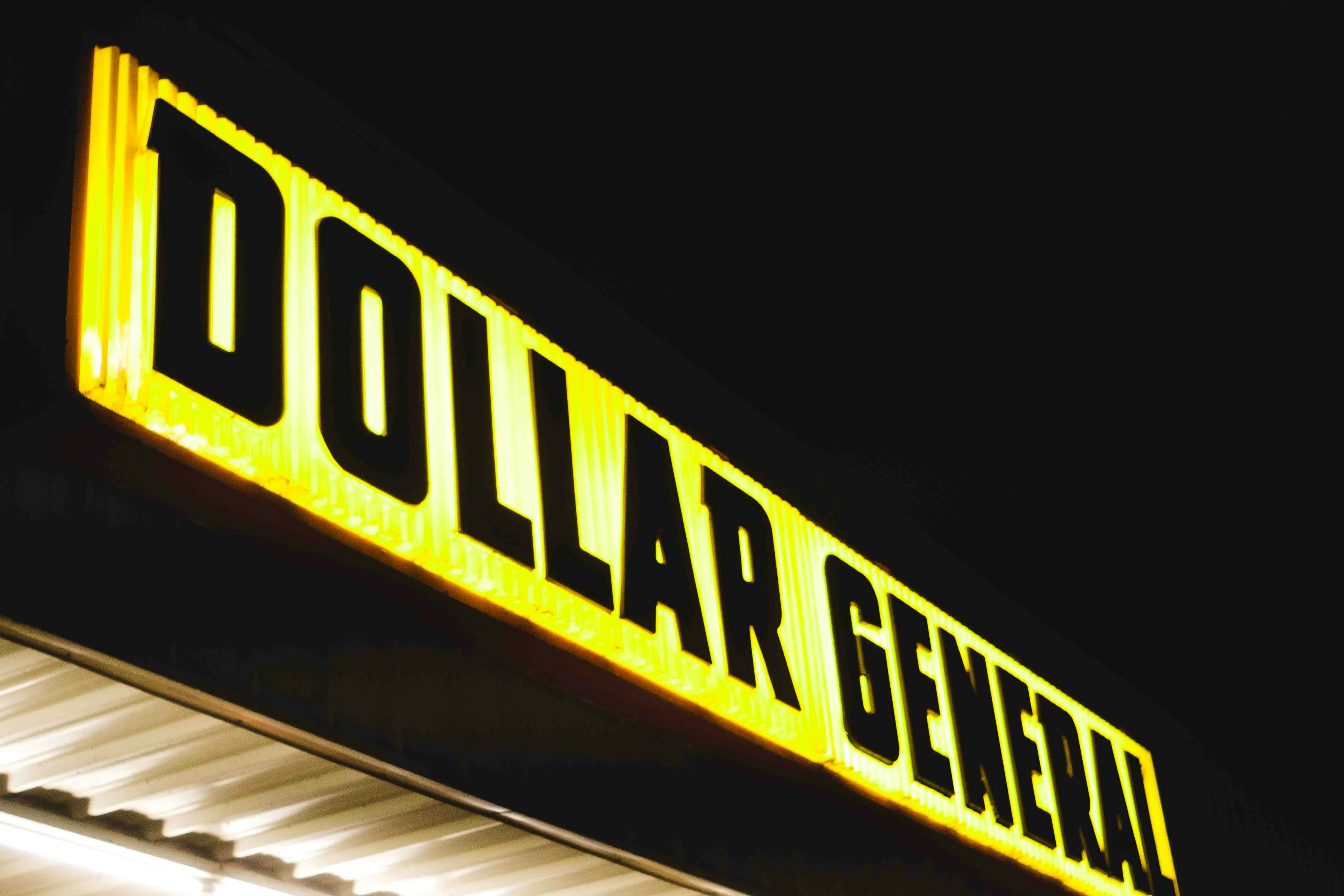 a dollar general store sign lit up at night