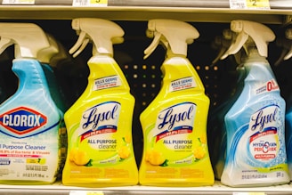 several bottles of lysol all purpose cleaner on a shelf