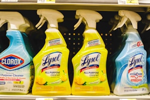 several bottles of lysol all purpose cleaner on a shelf