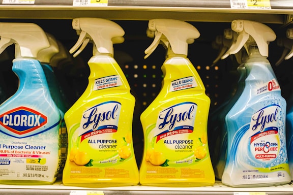 several bottles of lysol all purpose cleaner on a shelf
