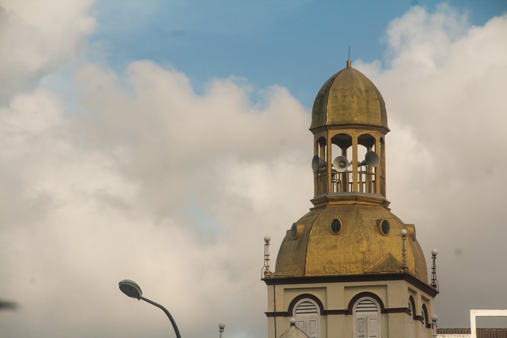 a clock tower with a gold dome on top