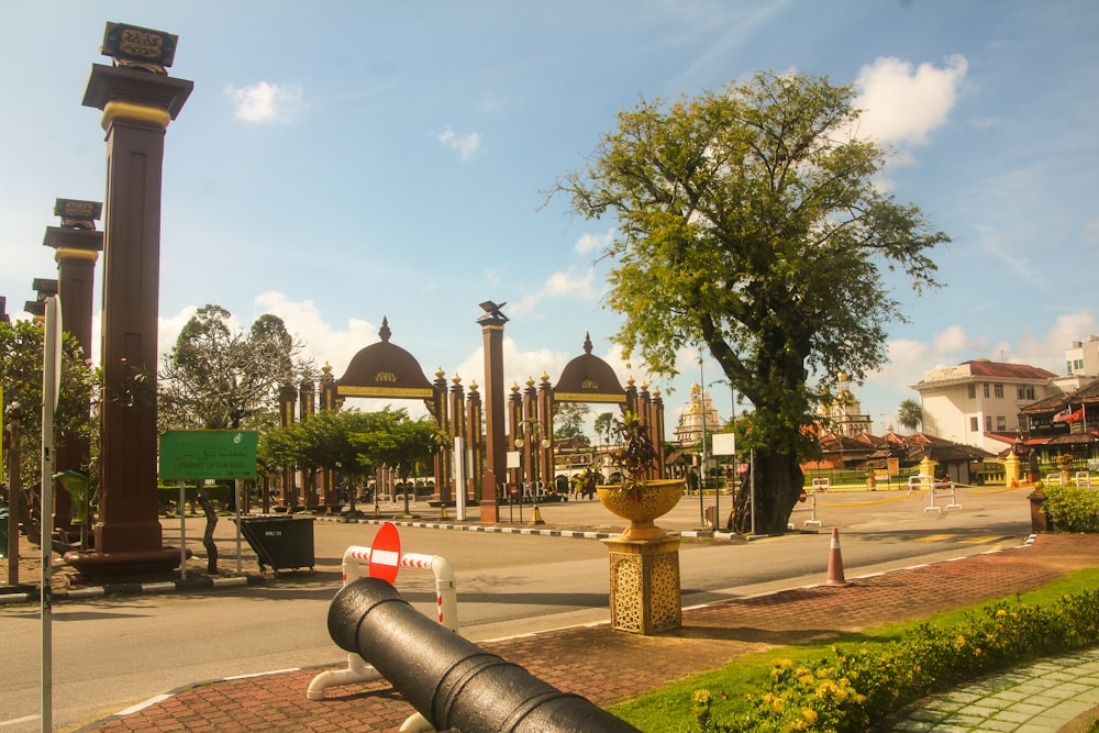 a large black cannon sitting on the side of a road