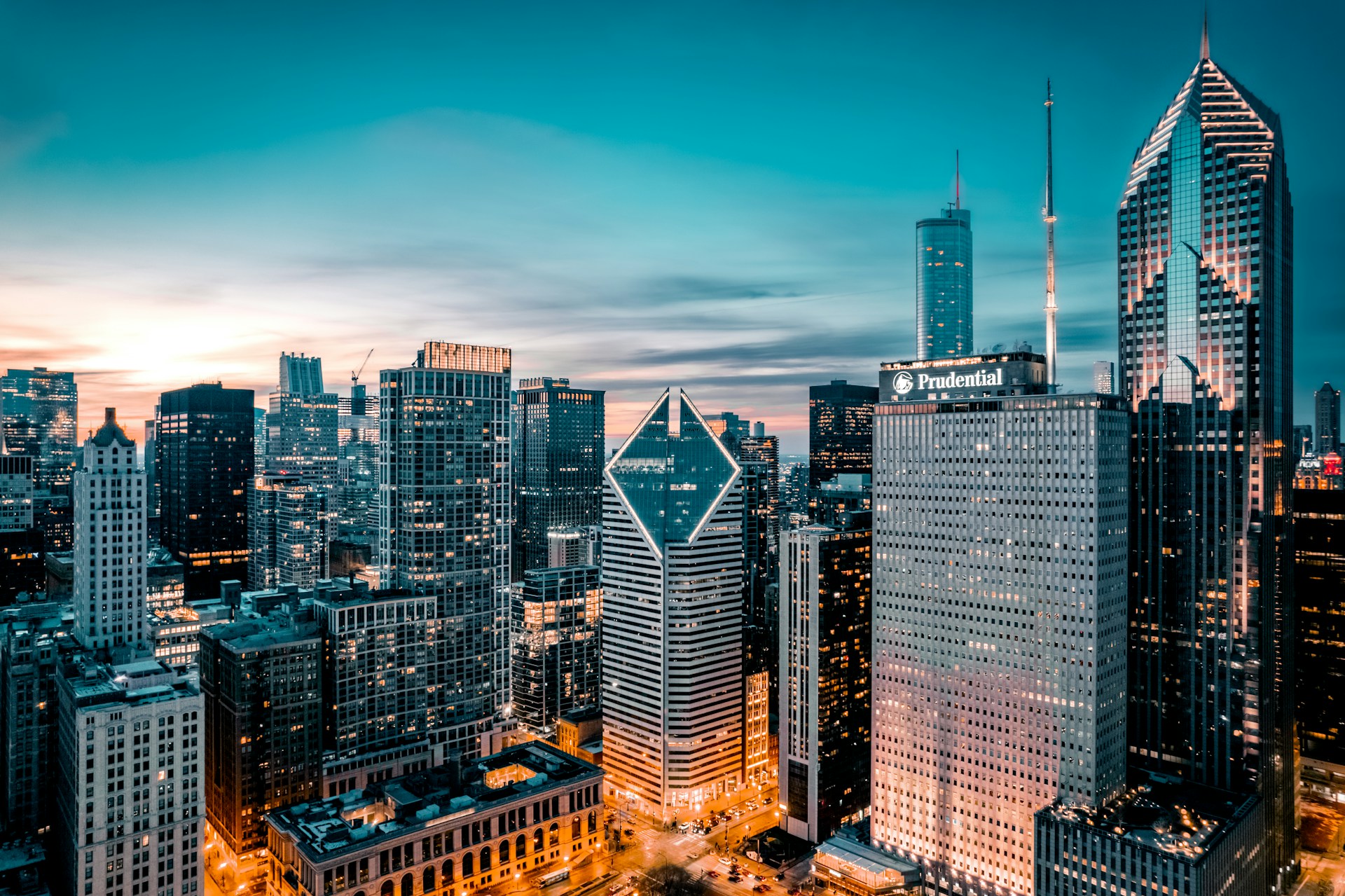a view of a city at night from the top of a skyscraper
