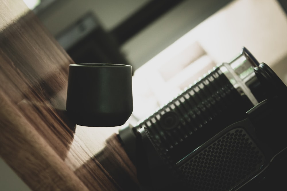 a coffee cup sitting on top of a wooden table