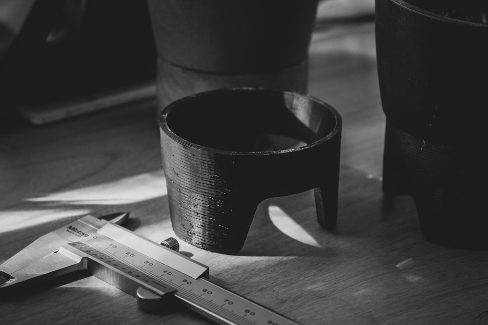 a pair of scissors sitting on top of a wooden table