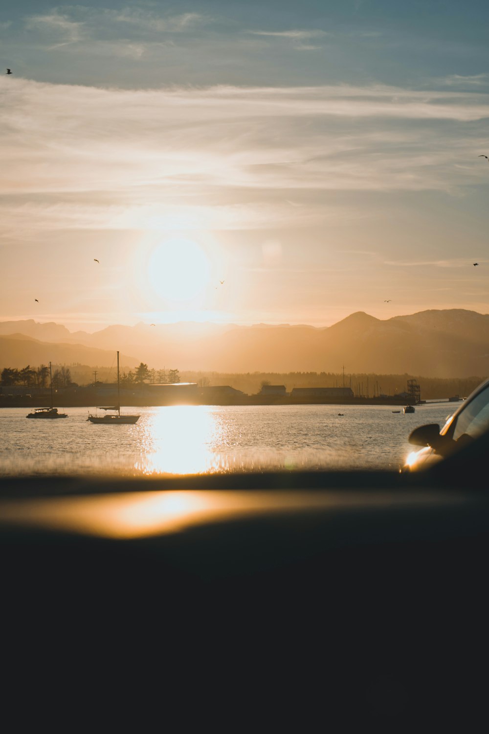 the sun is setting over a body of water