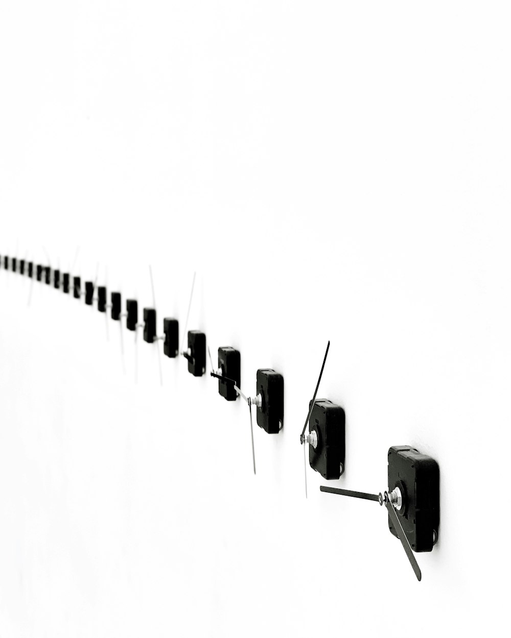 a long line of black objects on a white background