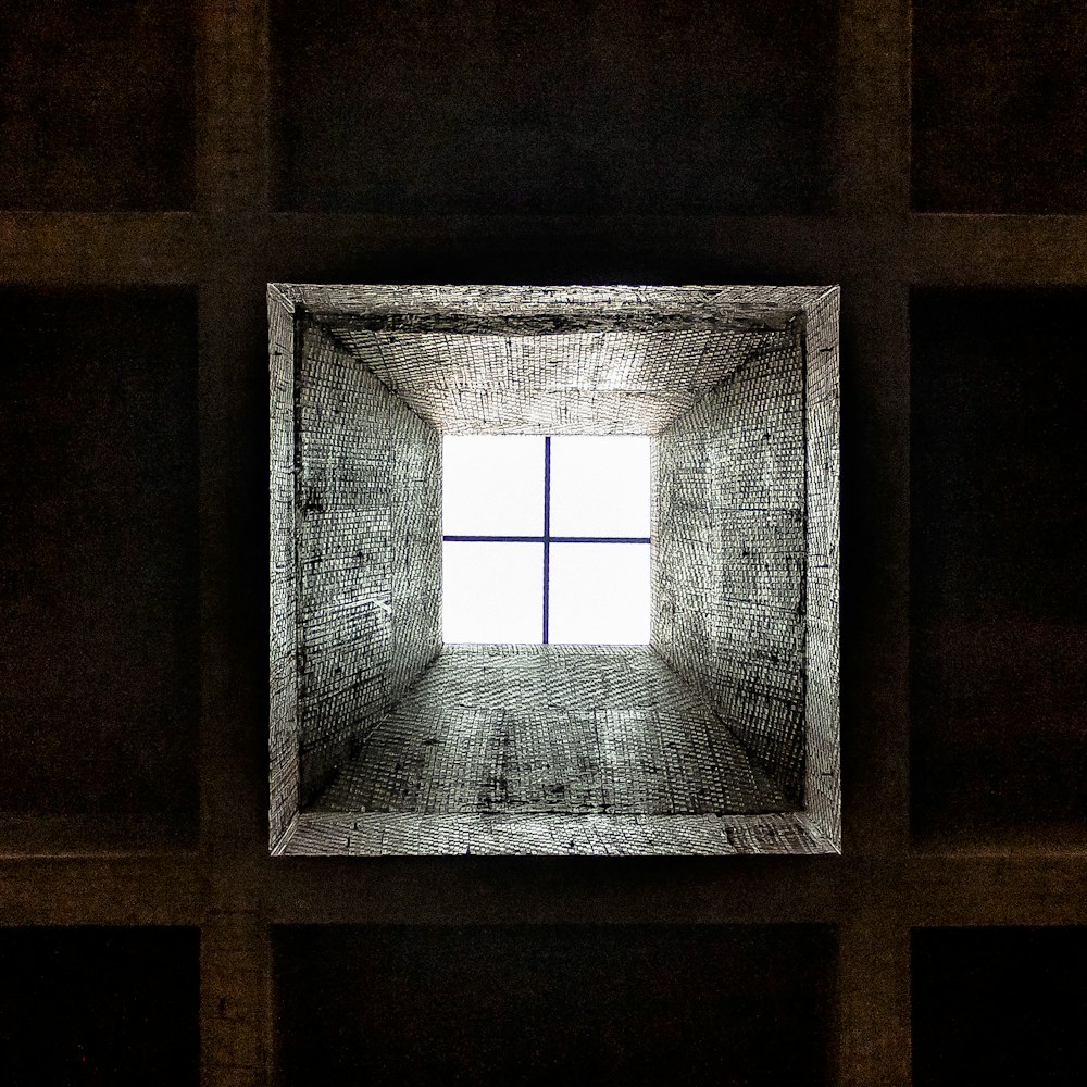 a room with a square window in the middle of it