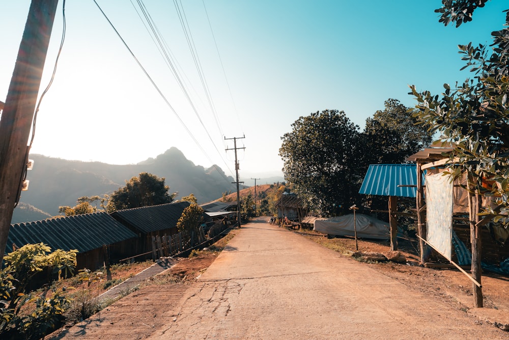 a dirt road surrounded by trees and mountains