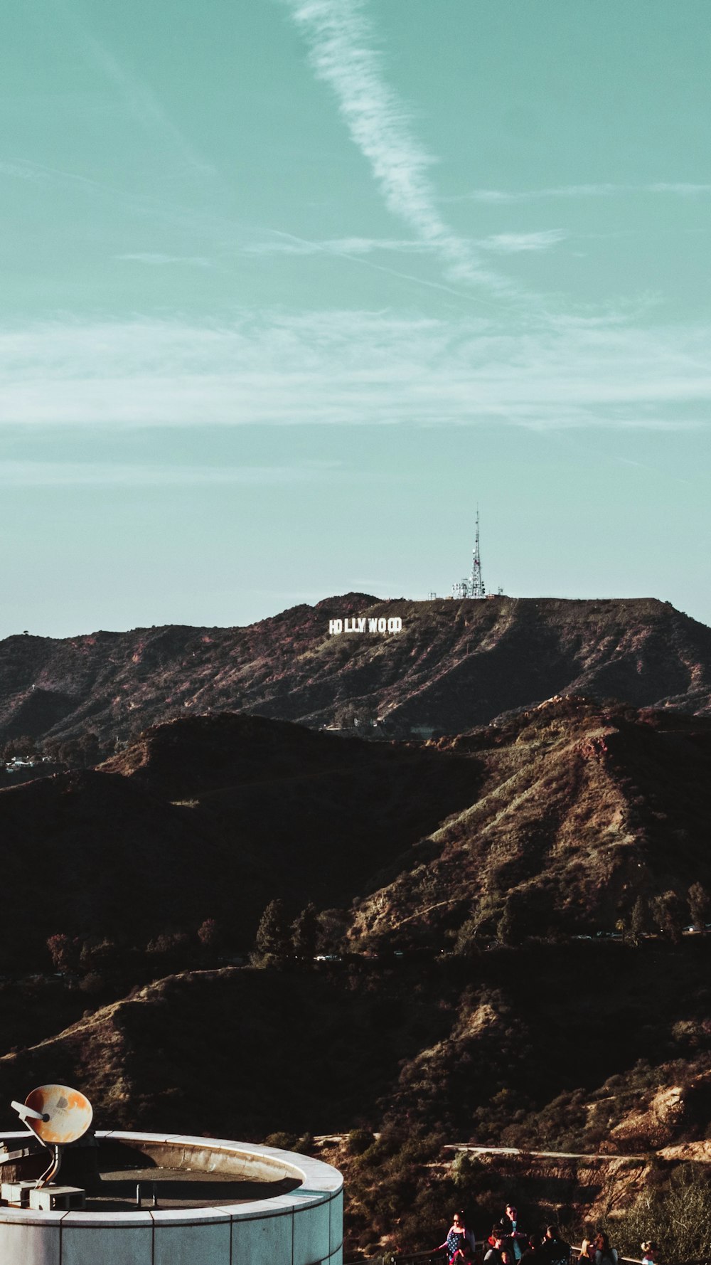 a group of people standing on top of a hill