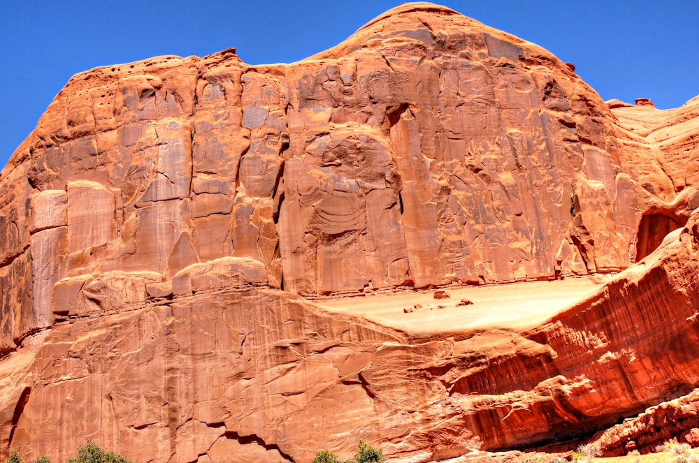 a large rock formation in the middle of a desert