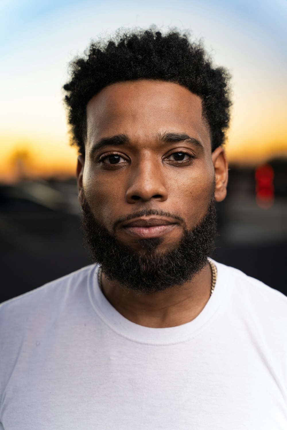 a man with a beard and a white shirt