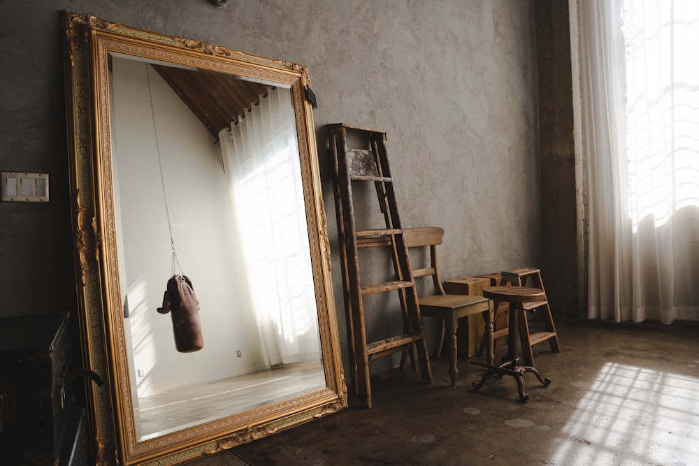 a room with a large mirror and a ladder