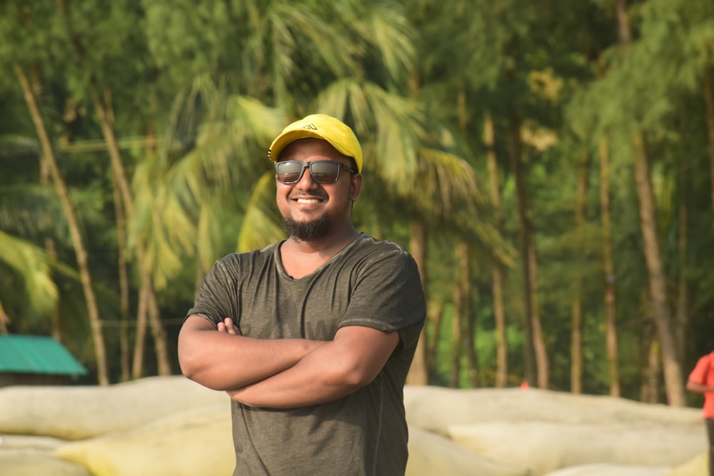 a man wearing a yellow hat and sunglasses