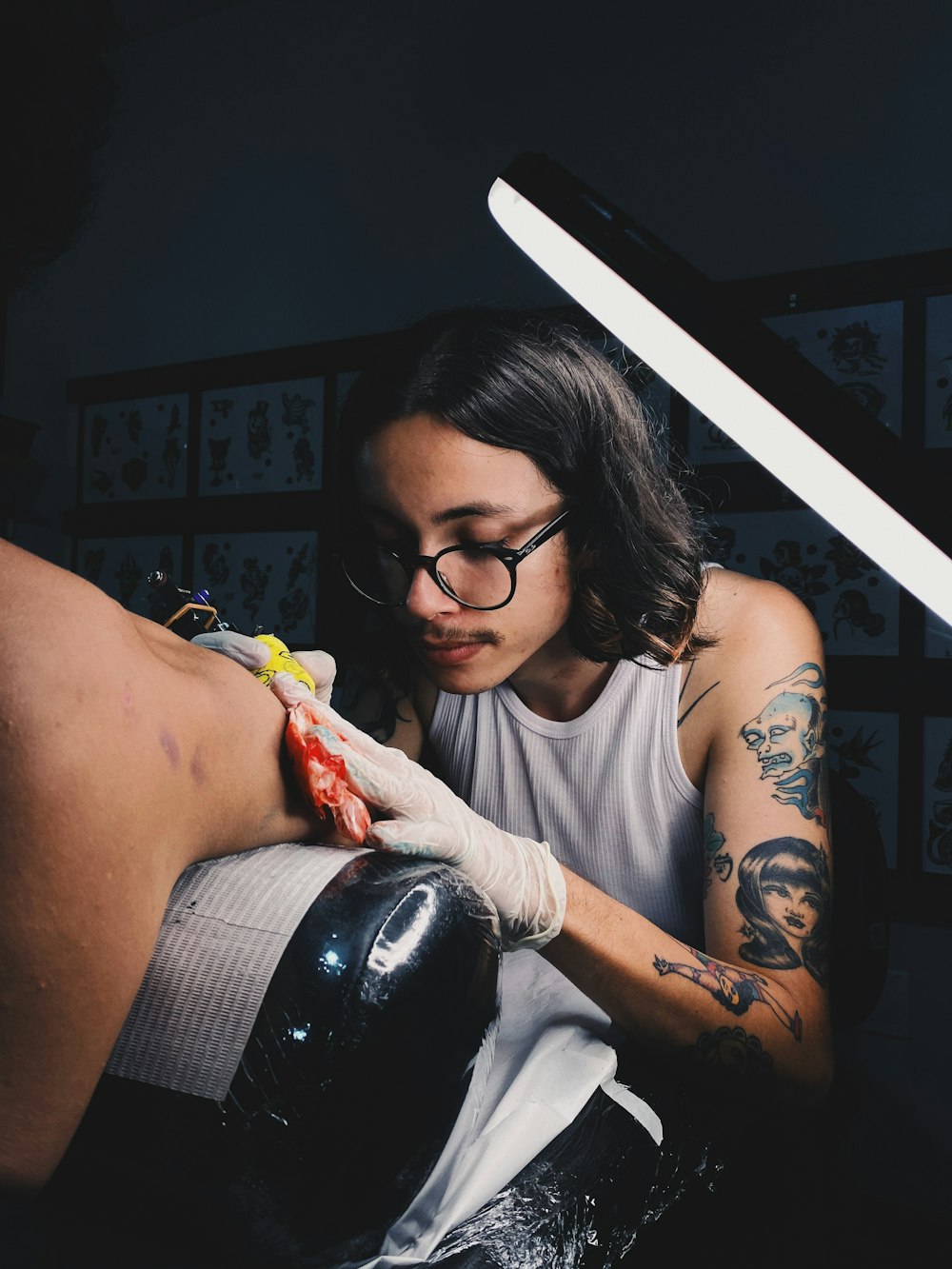 a woman getting a tattoo on her leg