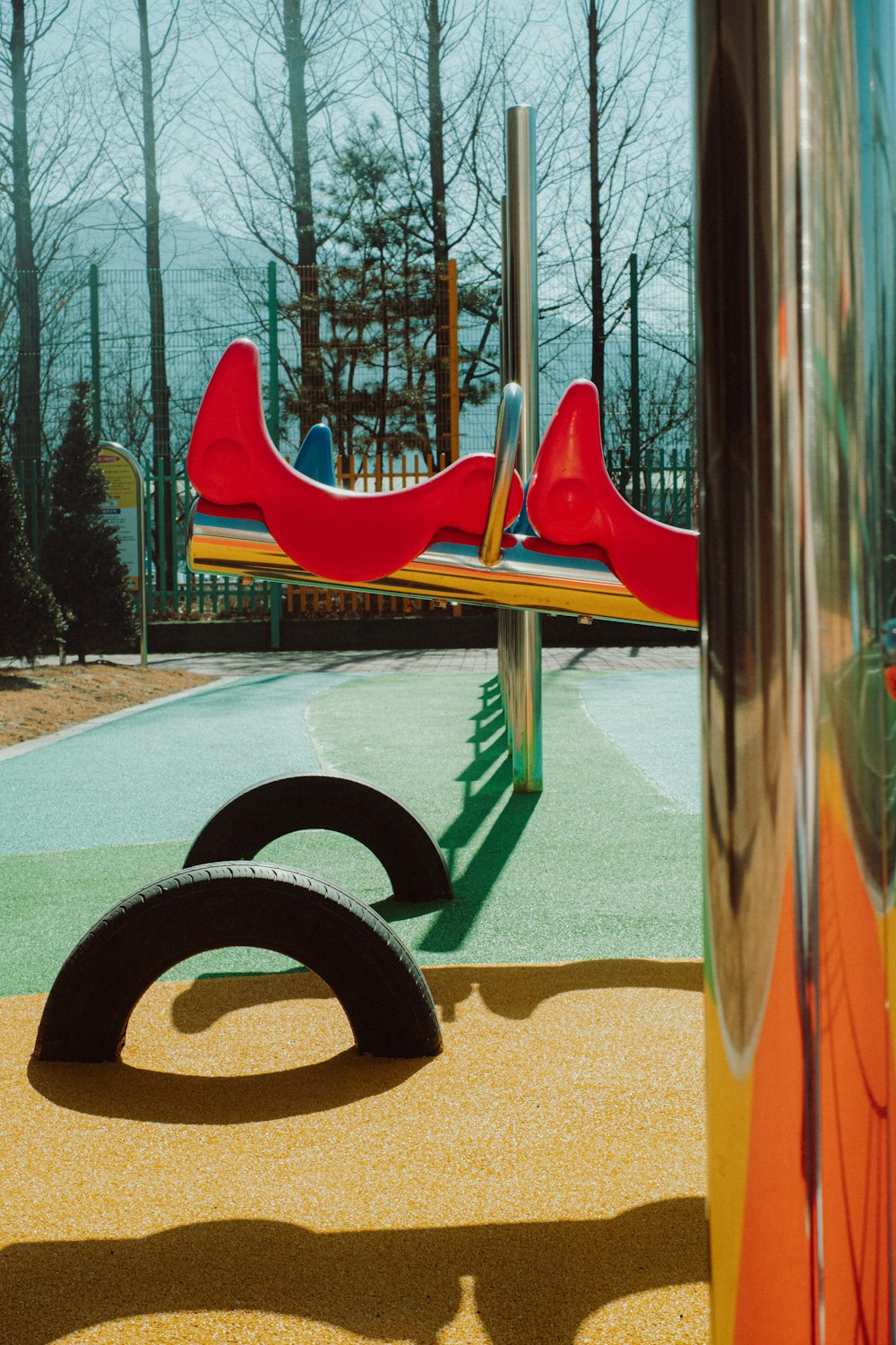 a children's play area in a park with a playground