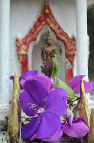 Close-up of colorful flowers and stone details around the Santuario de Las Lajas.