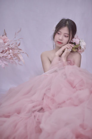 Soft pastel pink gown with flowing tulle skirt captured in natural light.