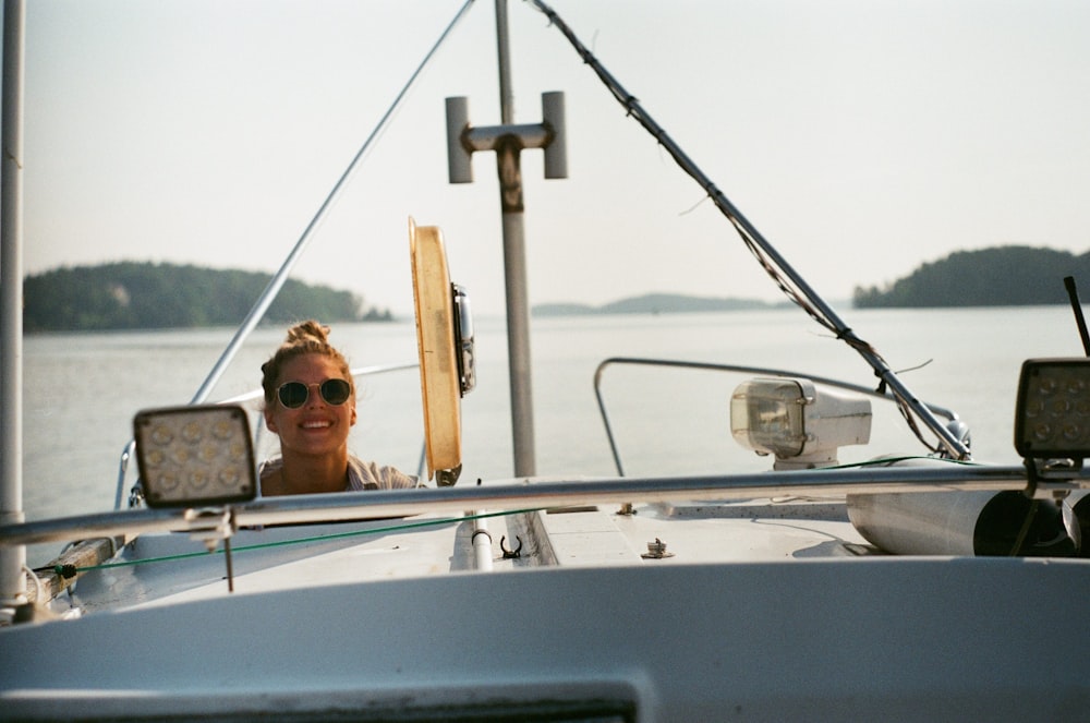 a woman sitting on a boat in the water