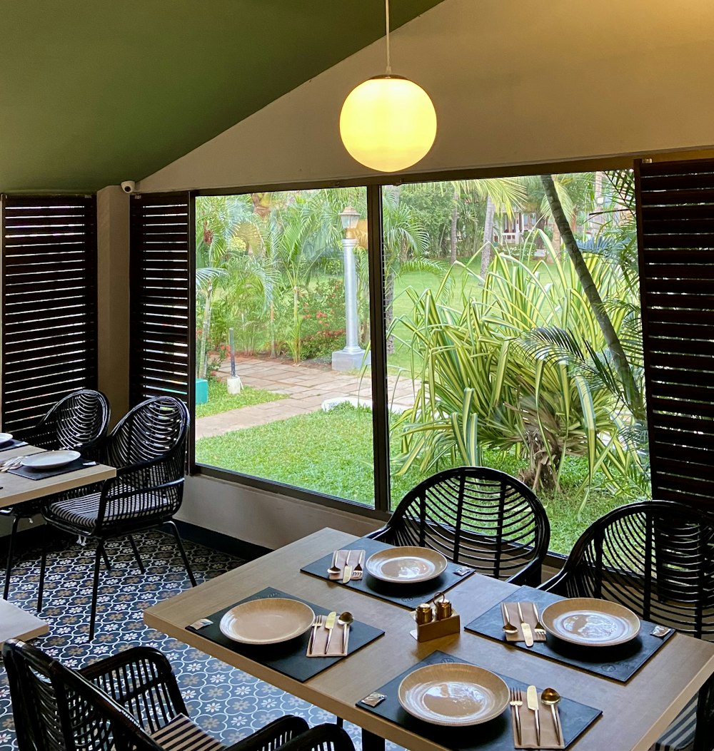 a dining room with a view of a garden