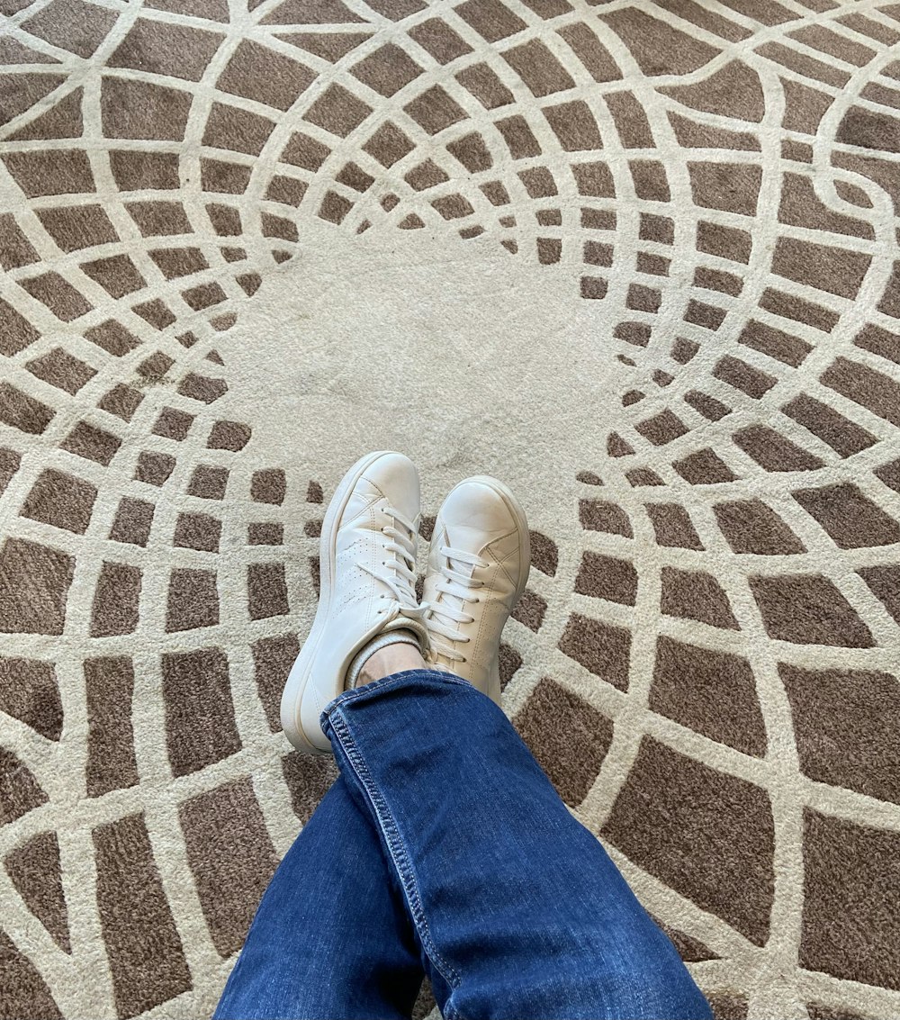 a person standing on a carpet with their feet up