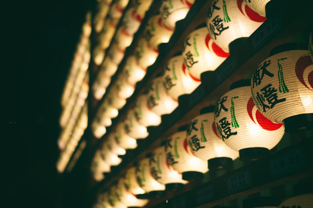 a row of paper lanterns with asian writing on them