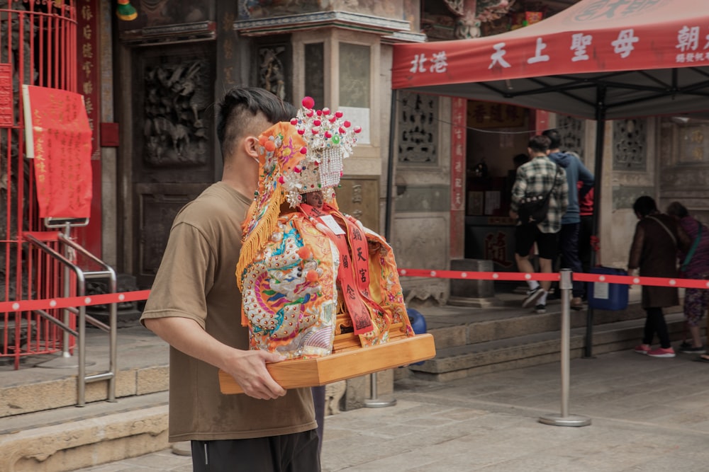 a man carrying a large piece of cloth on his back