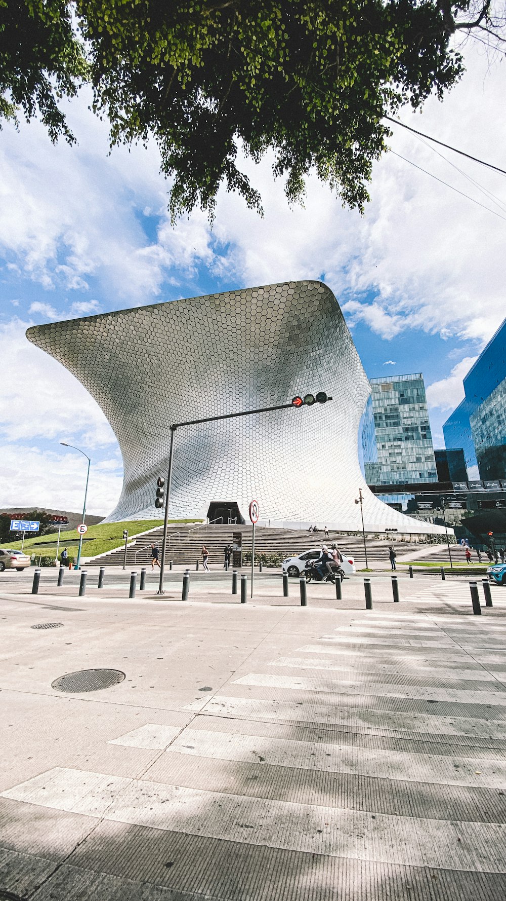 a large building with a curved roof on a sunny day