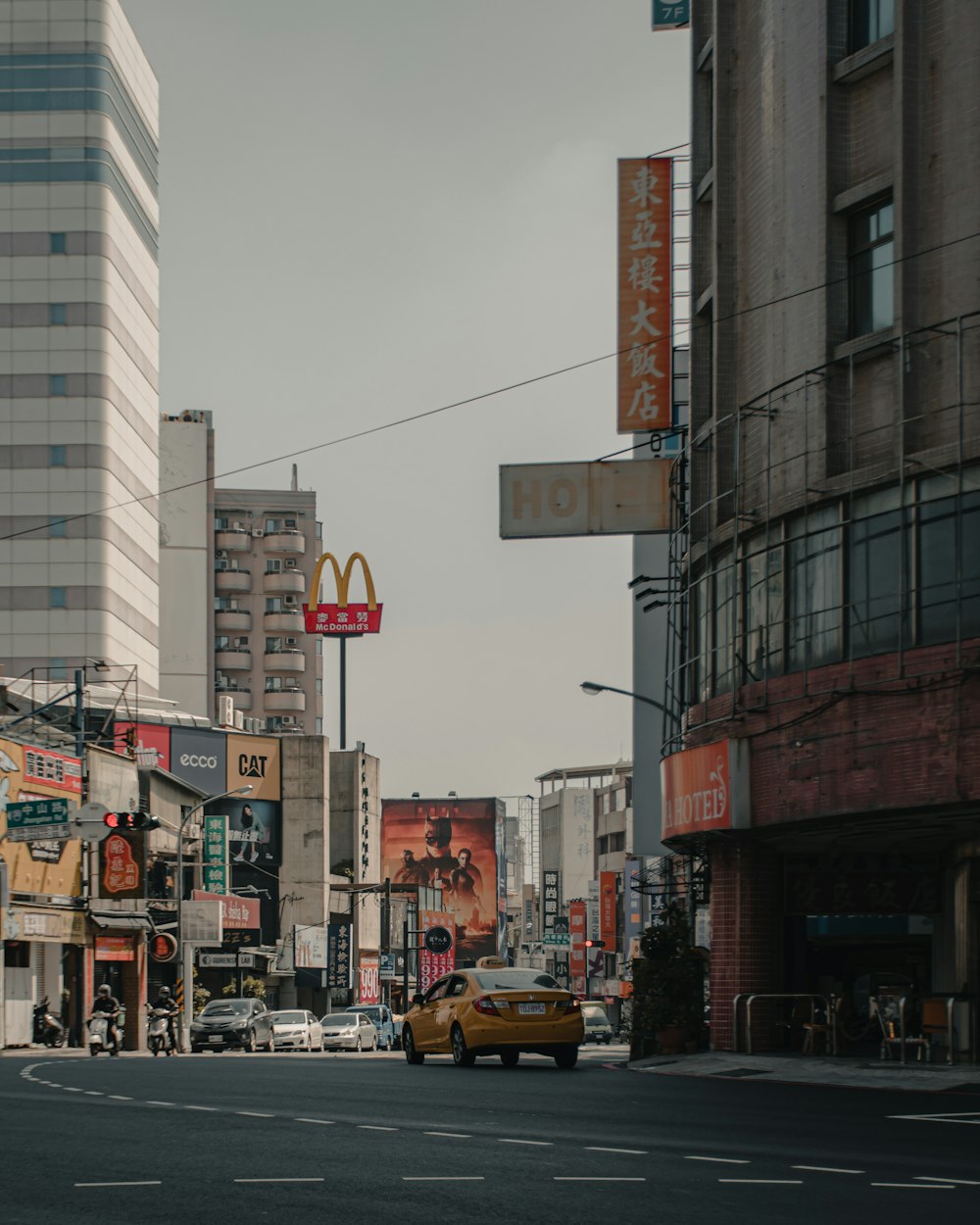a city street with a mcdonald's sign in the distance