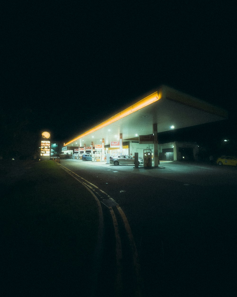 a gas station lit up at night time