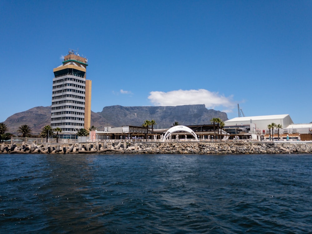 a tall building sitting next to a body of water