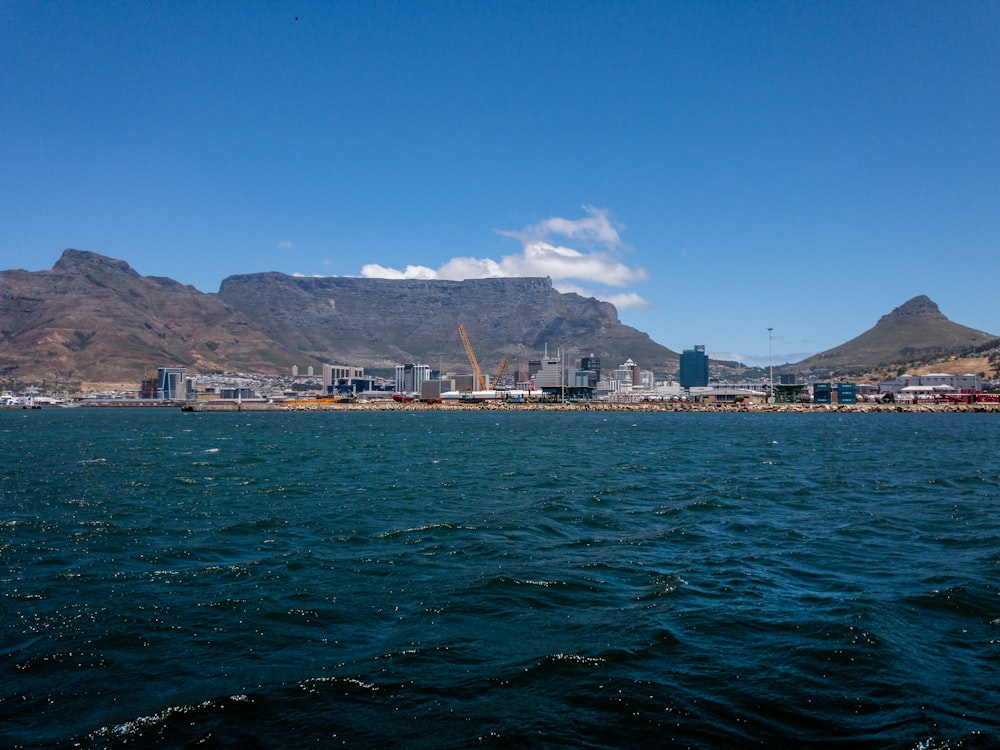 a large body of water with mountains in the background