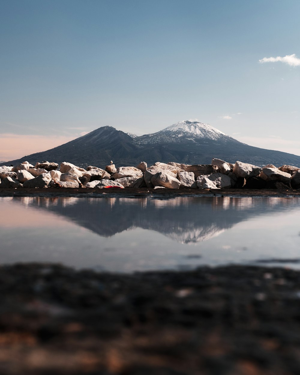 a large body of water with a mountain in the background