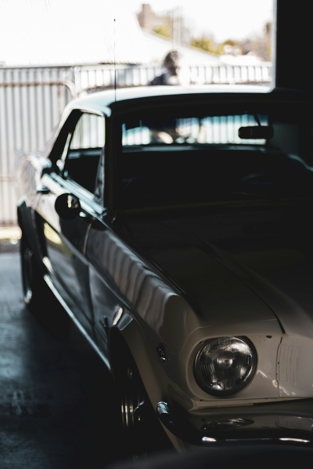 a car parked in a garage next to another car