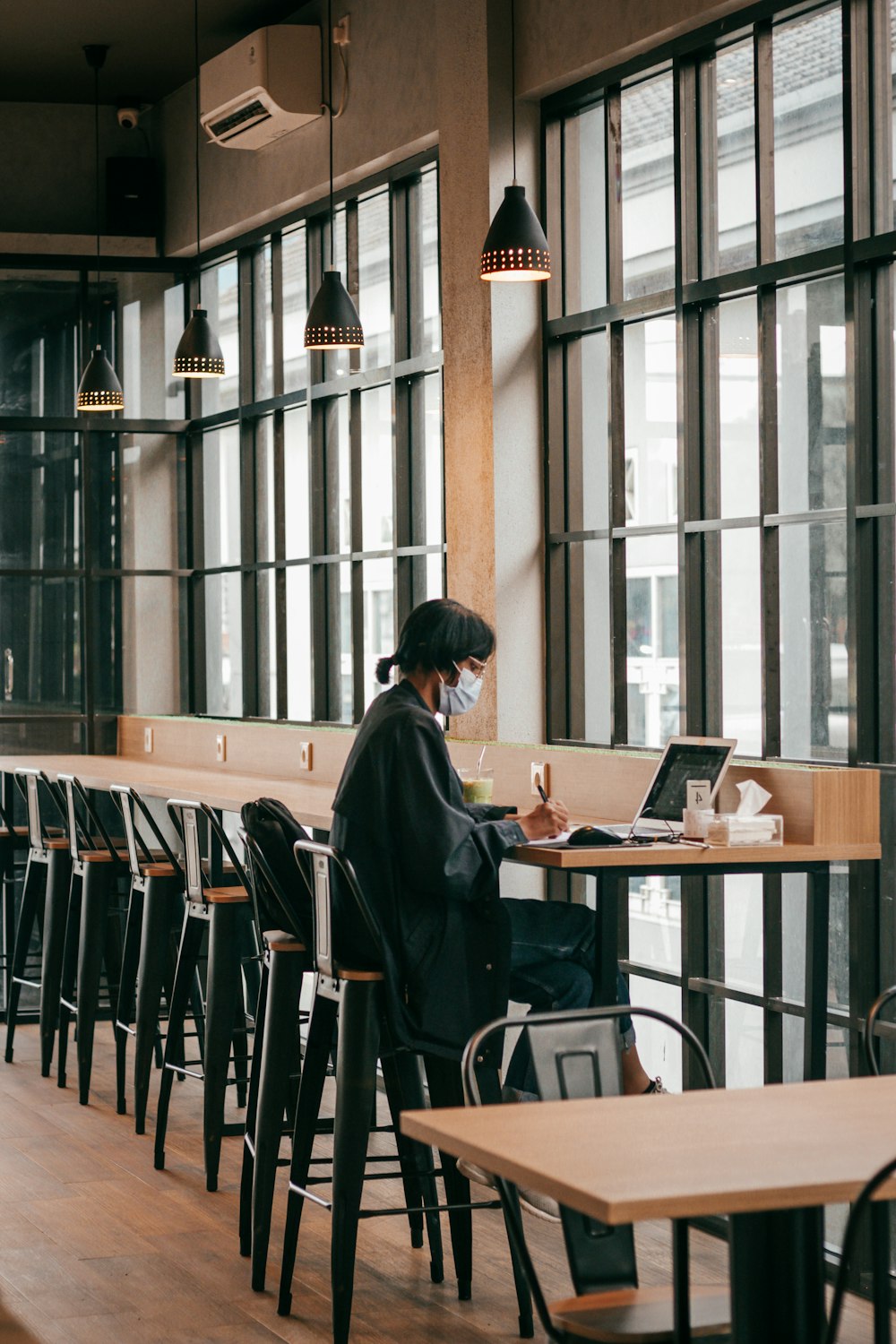 a person sitting at a table with a laptop