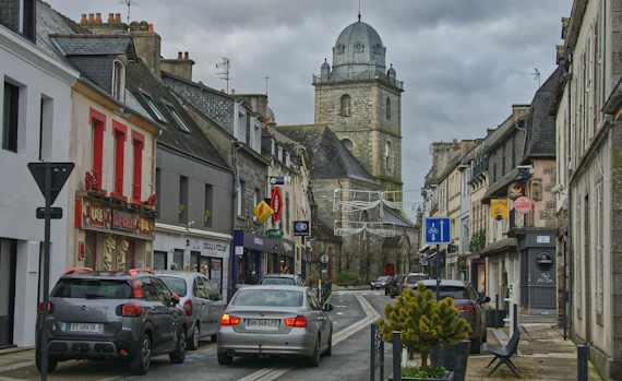 a city street with cars parked on both sides of the street